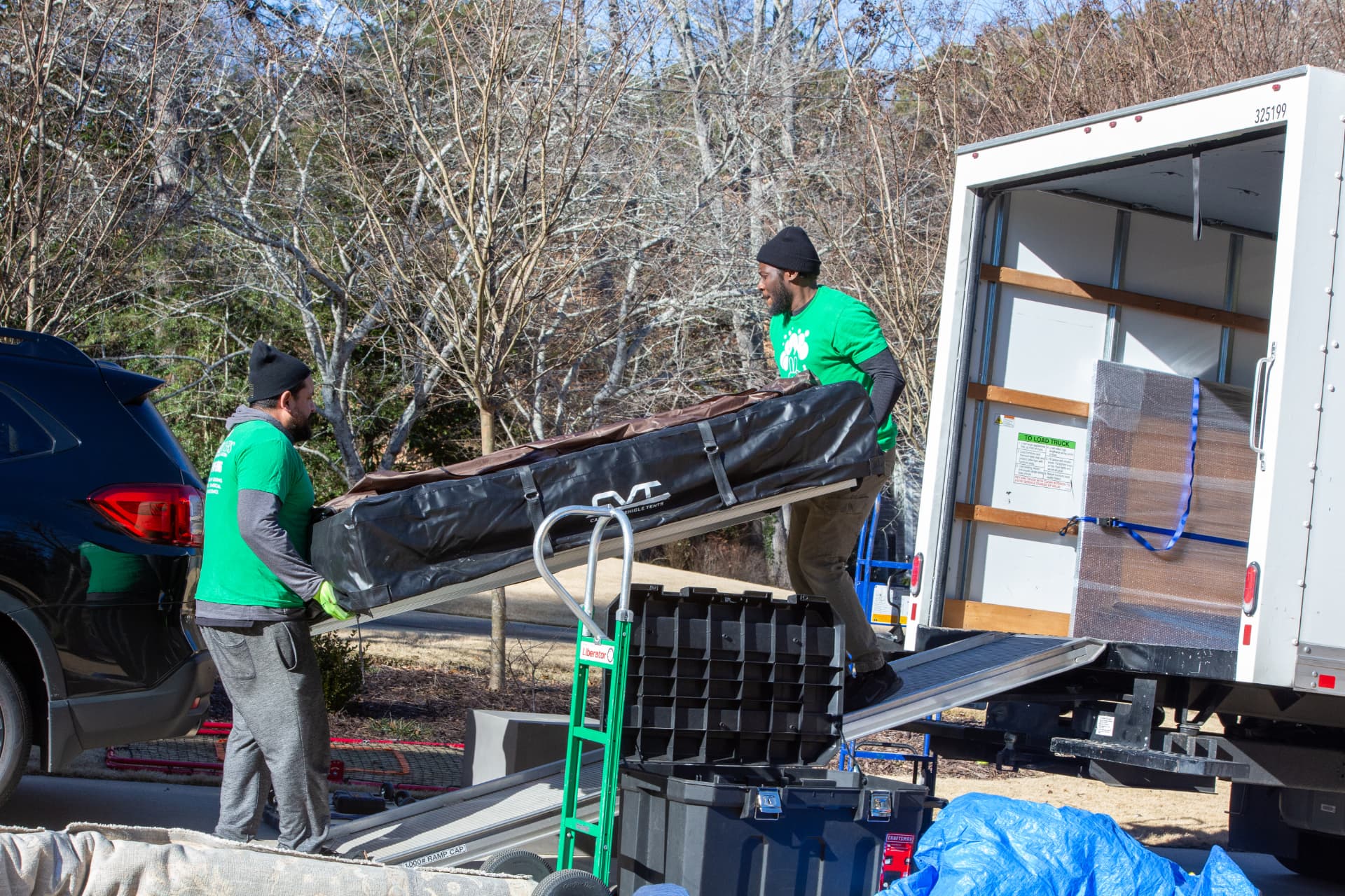 Emerald Movers loading a large item up the ramp into a moving truck